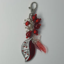 Load image into Gallery viewer, Planner/purse charm. Silver leaf pendant with red stone inlay accompanied by mixed media beads, silver findings and lobster clasp.