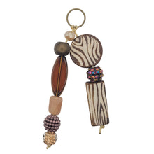 Load image into Gallery viewer, Decorative keychain with zebra print and wooden beads on a white background