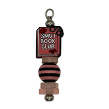 Load image into Gallery viewer, Handmade "Chapter 69" silver Luxe Pillar purse charm with a "Smut Book Club" book focal bead and pink/black striped accents, cheeky spicy romance reader accessory.