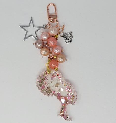 Dope Black Girl Glam purse charm by Bougie Girl Boutique, featuring a sparkling pink and rose gold theme, resin afro silhouette, pink and rose gold beads, a silver star, and a 'Dope Black Girl' charm.