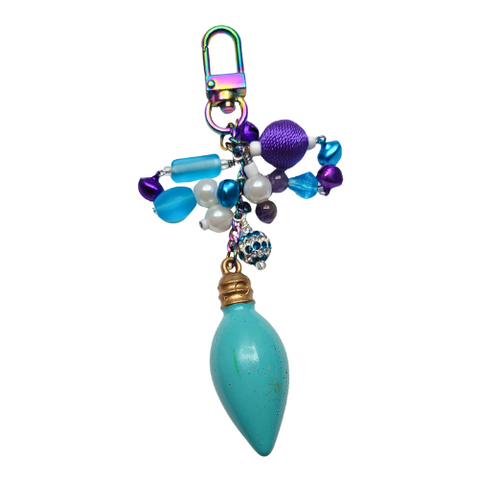 Handmade holiday light charm with jewel-toned beads, including purple and blue jingle bells that make a soft chime, and a turquoise lightbulb focal bead.
