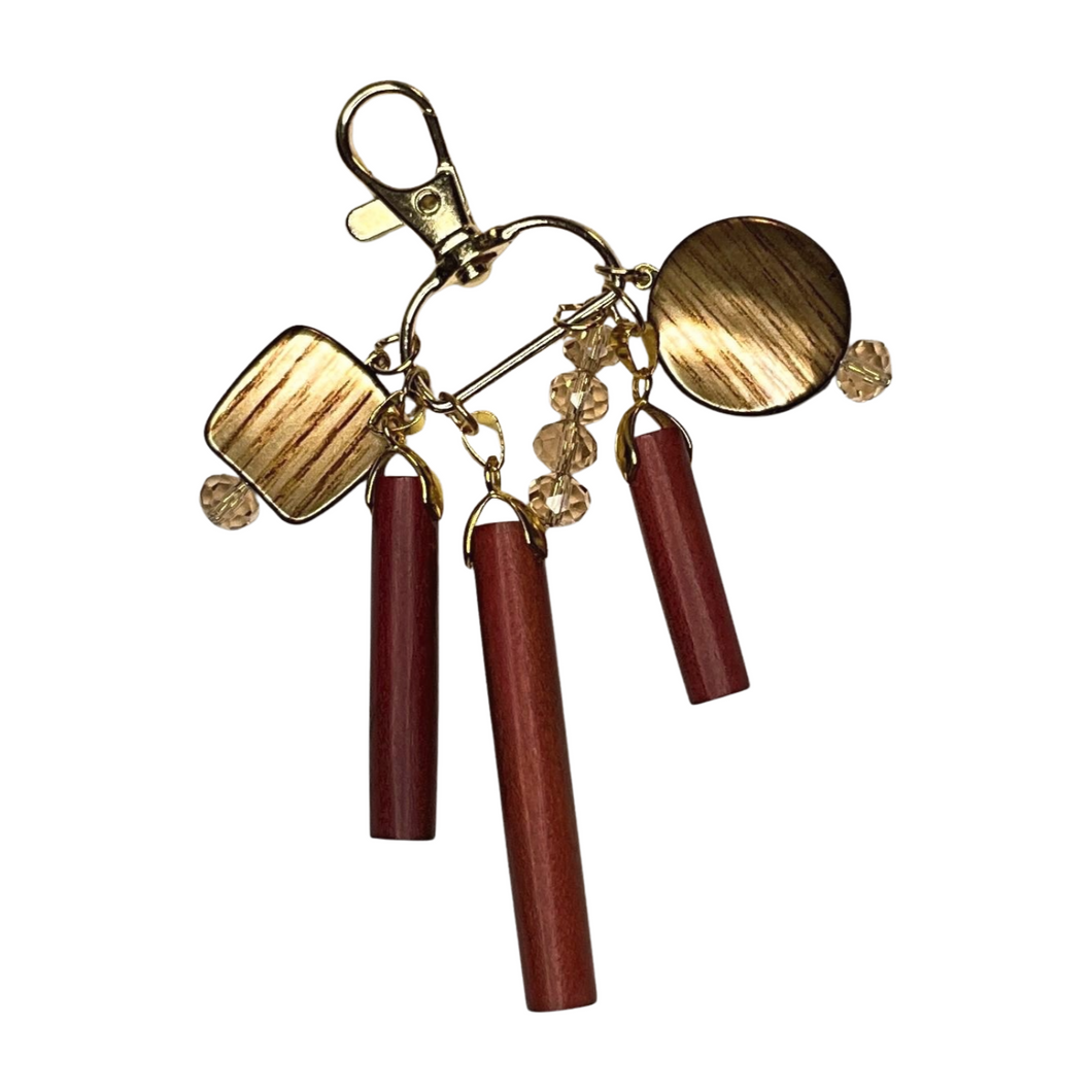 Woodland Glimmer Purse Charm featuring rustic wooden accents, gold-tone metal hardware, and sparkling crystal beads, elegantly designed for handbags, backpacks, or keychains.