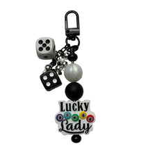 Load image into Gallery viewer, A black keychain charm featuring two white and black dice, a white pearl bead, a black bead, and a white acrylic charm with the words 'Lucky Lady' and colorful bingo balls.