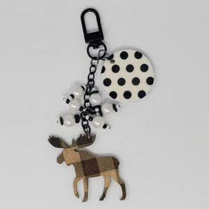 Moosey Dots purse charm by Bougie Girl Boutique, featuring a wooden moose with plaid pattern, black and white polka dot disc, and white beads.