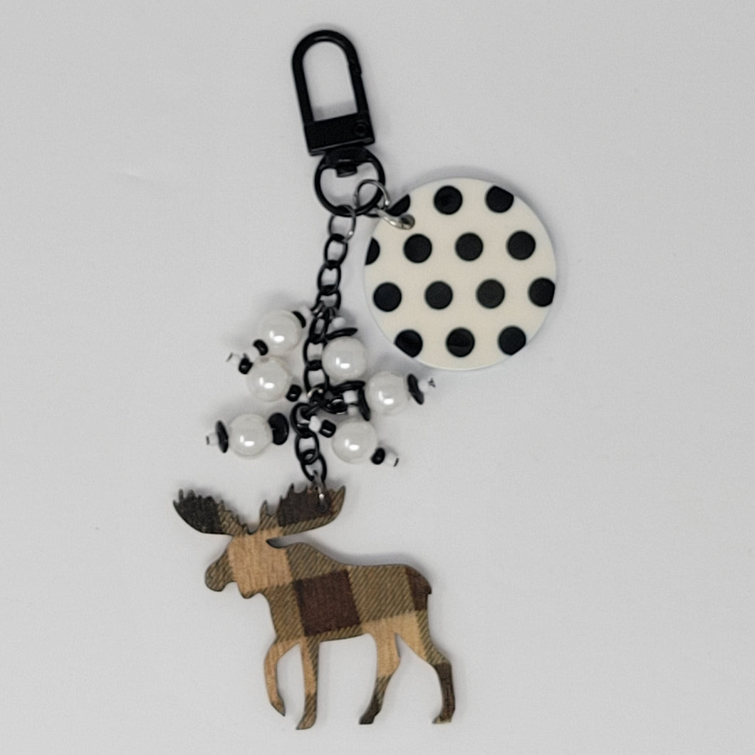 Moosey Dots purse charm by Bougie Girl Boutique, featuring a wooden moose with plaid pattern, black and white polka dot disc, and white beads.